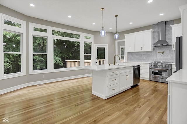 7131 Nile Ridge Ct, Indianapolis, IN 46236 - kitchen with wall chimney range hood, stainless steel appliances, healthy amount of natural light, light countertops, and recessed lighting