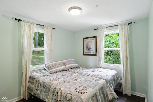 8453 S Christian Dr, Princes Lakes, IN 46164 - bedroom featuring baseboards and dark wood-style floors