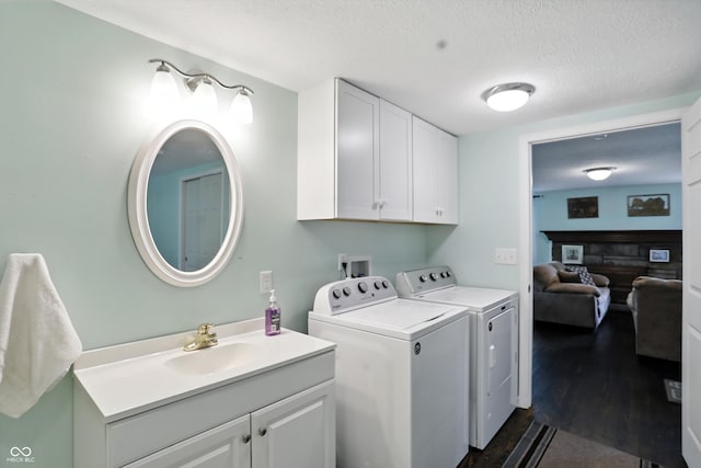 8453 S Christian Dr, Princes Lakes, IN 46164 - laundry area with washer and dryer, cabinet space, a textured ceiling, and dark wood-style flooring