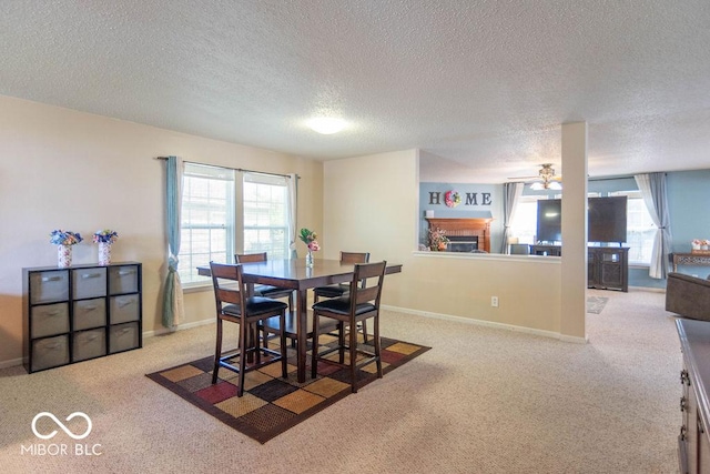 8703 Mellot Way, Camby, IN 46113 - carpeted dining area with a glass covered fireplace, a textured ceiling, plenty of natural light, and ceiling fan