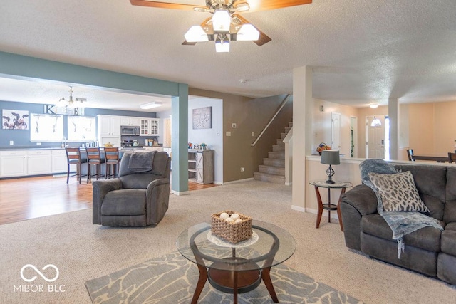8703 Mellot Way, Camby, IN 46113 - living area with light colored carpet, a textured ceiling, a ceiling fan, stairs, and a chandelier