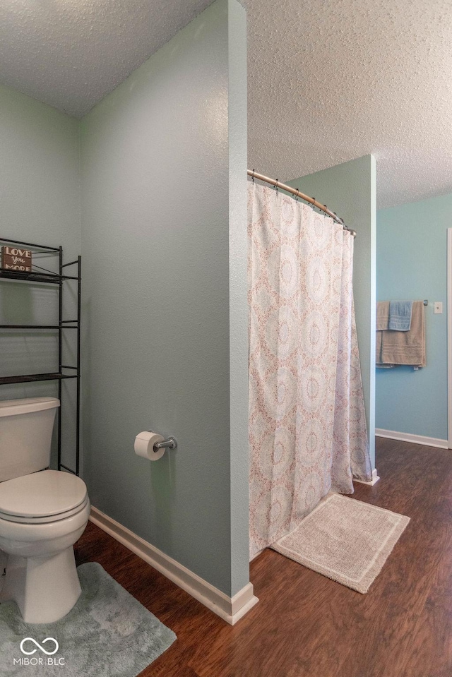8703 Mellot Way, Camby, IN 46113 - full bathroom featuring wood finished floors, a textured ceiling, and a shower with shower curtain