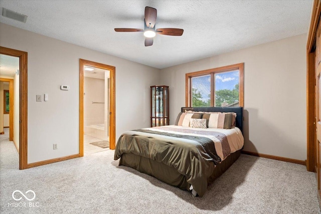 5298 Royal Troon Way, Avon, IN 46123 - bedroom with light carpet, a textured ceiling, connected bathroom, and ceiling fan