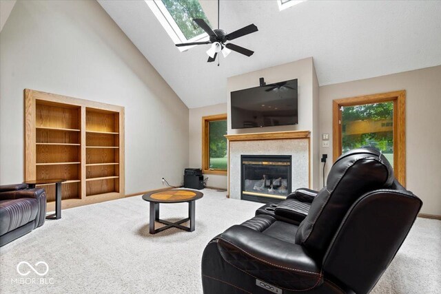 5298 Royal Troon Way, Avon, IN 46123 - carpeted living room featuring a skylight, high vaulted ceiling, ceiling fan, and a glass covered fireplace