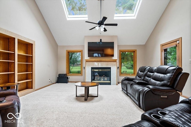5298 Royal Troon Way, Avon, IN 46123 - carpeted living room with a skylight, high vaulted ceiling, a tiled fireplace, ceiling fan, and built in shelves