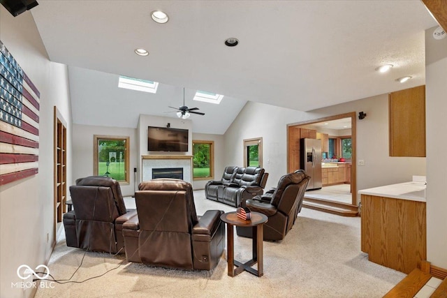 5298 Royal Troon Way, Avon, IN 46123 - living area featuring a skylight, light colored carpet, a fireplace, a ceiling fan, and recessed lighting
