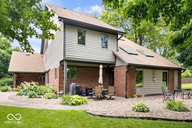 5298 Royal Troon Way, Avon, IN 46123 - back of property featuring a patio, brick siding, a yard, and roof with shingles