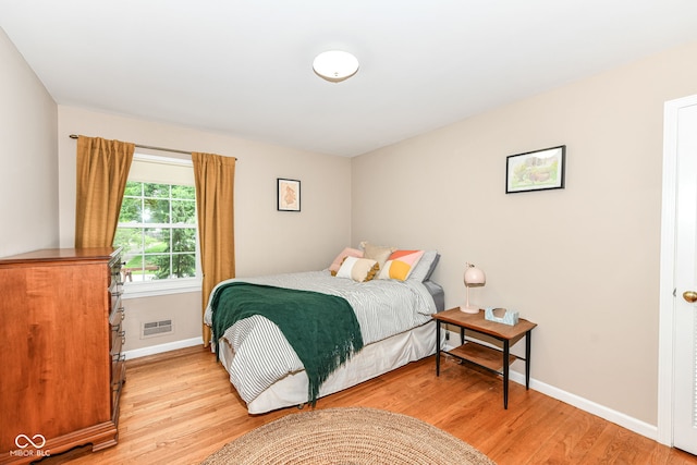 7014 Creekside Ln, Indianapolis, IN 46220 - bedroom with light wood-type flooring and baseboards