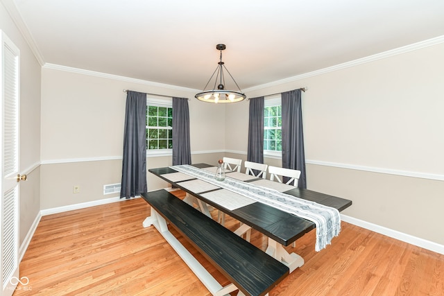 7014 Creekside Ln, Indianapolis, IN 46220 - dining space featuring light wood-style floors, a chandelier, and crown molding