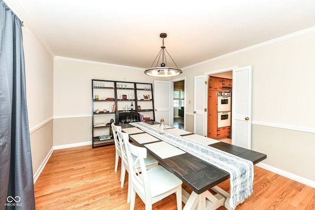7014 Creekside Ln, Indianapolis, IN 46220 - dining space with light wood-type flooring, crown molding, a chandelier, and a desk