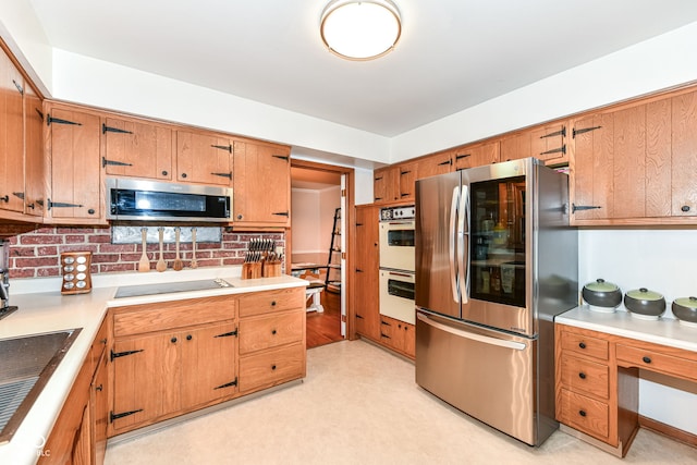 7014 Creekside Ln, Indianapolis, IN 46220 - kitchen with stainless steel appliances, decorative backsplash, brown cabinetry, and light countertops