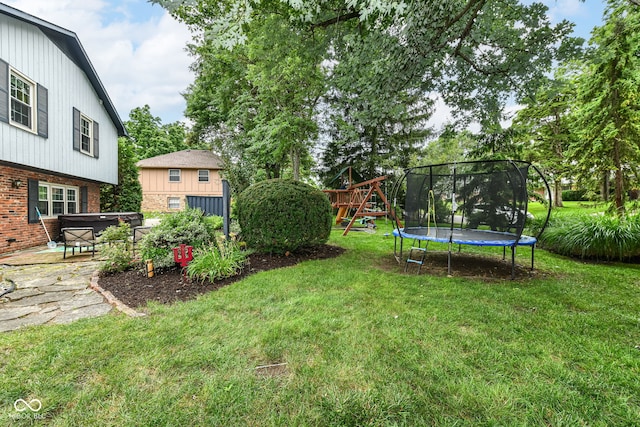 7014 Creekside Ln, Indianapolis, IN 46220 - view of grassy yard featuring a jacuzzi, a trampoline, and a playground
