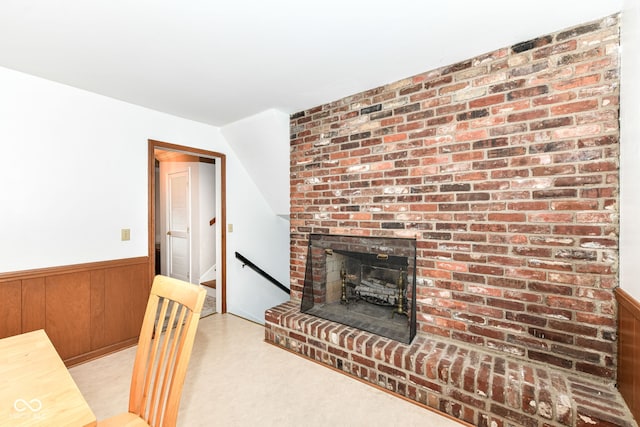 7014 Creekside Ln, Indianapolis, IN 46220 - living area with a wainscoted wall, wooden walls, and a brick fireplace