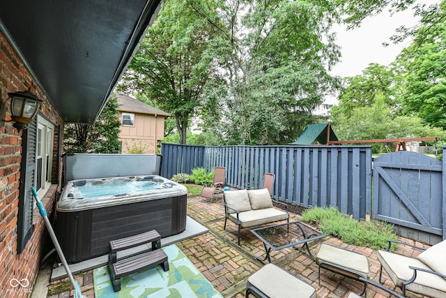 7014 Creekside Ln, Indianapolis, IN 46220 - view of patio / terrace featuring a hot tub, a gate, and an outdoor living space