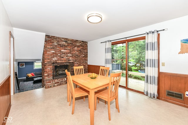 7014 Creekside Ln, Indianapolis, IN 46220 - dining area featuring a wainscoted wall, a fireplace, and wood walls