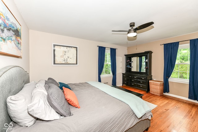7014 Creekside Ln, Indianapolis, IN 46220 - bedroom with light wood finished floors and ceiling fan