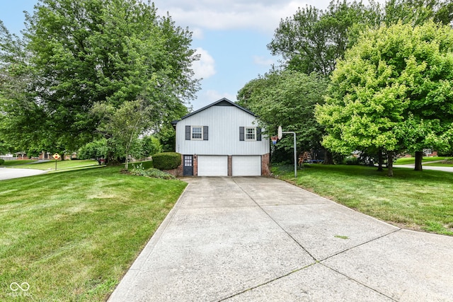 7014 Creekside Ln, Indianapolis, IN 46220 - view of side of home with a garage, a yard, concrete driveway, and brick siding