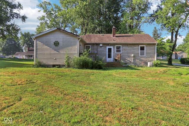 202 W Elbert St, Indianapolis, IN 46217 - back of house with a chimney, a lawn, stone siding, and entry steps