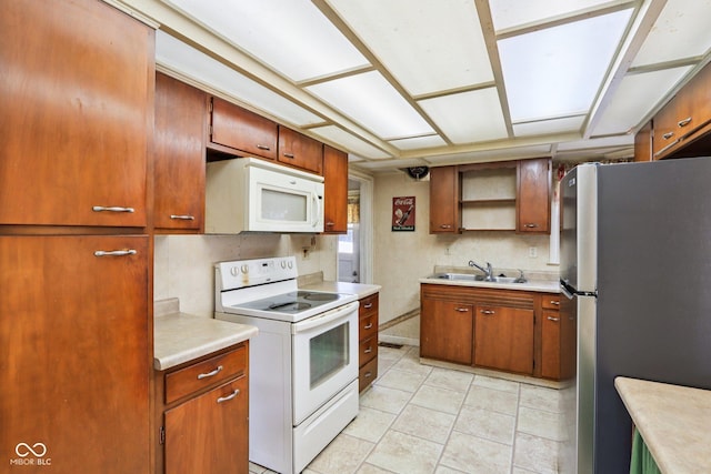 202 W Elbert St, Indianapolis, IN 46217 - kitchen featuring white appliances, light countertops, open shelves, and brown cabinets