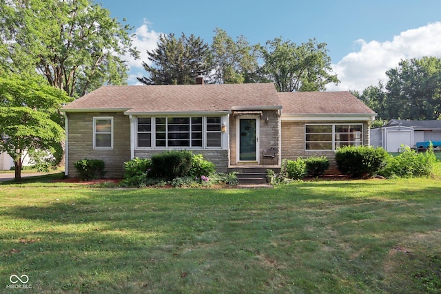 202 W Elbert St, Indianapolis, IN 46217 - view of front of house with stone siding, a front lawn, and a chimney