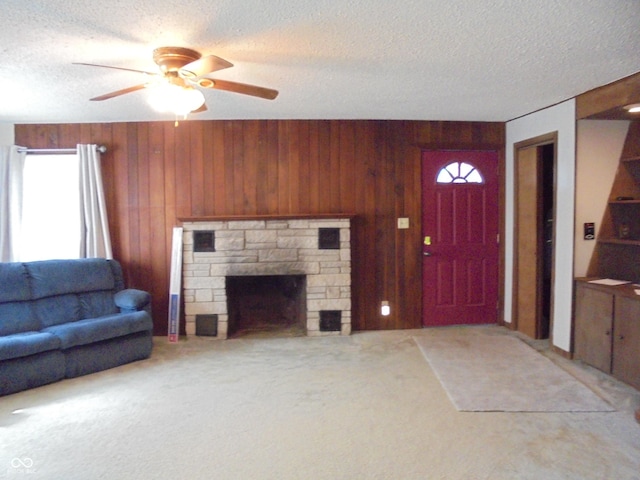 219 S Main St, Modoc, IN 47358 - living area featuring healthy amount of natural light, wooden walls, a textured ceiling, a ceiling fan, and light carpet