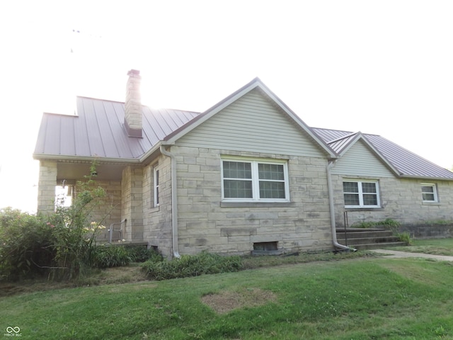 219 S Main St, Modoc, IN 47358 - view of home's exterior featuring stone siding, a metal roof, a standing seam roof, and a chimney
