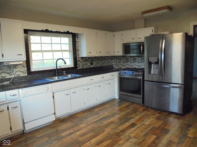 219 S Main St, Modoc, IN 47358 - kitchen featuring stainless steel appliances, white cabinets, decorative backsplash, and dark wood finished floors