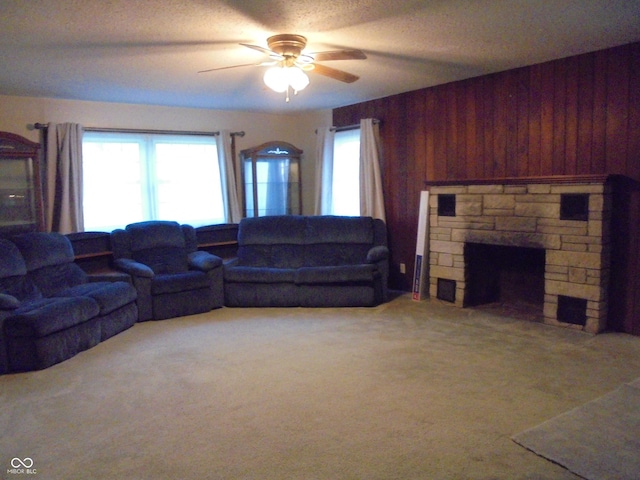 219 S Main St, Modoc, IN 47358 - living area featuring ceiling fan, wooden walls, a fireplace, and carpet floors