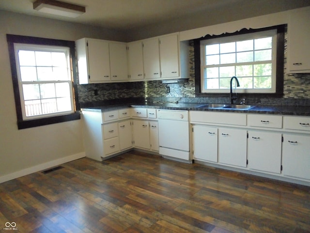 219 S Main St, Modoc, IN 47358 - kitchen with dishwasher, decorative backsplash, white cabinets, and dark countertops