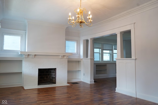 3554 N Illinois St, Indianapolis, IN 46208 - unfurnished living room featuring ornamental molding, wood finished floors, a chandelier, built in features, and a brick fireplace