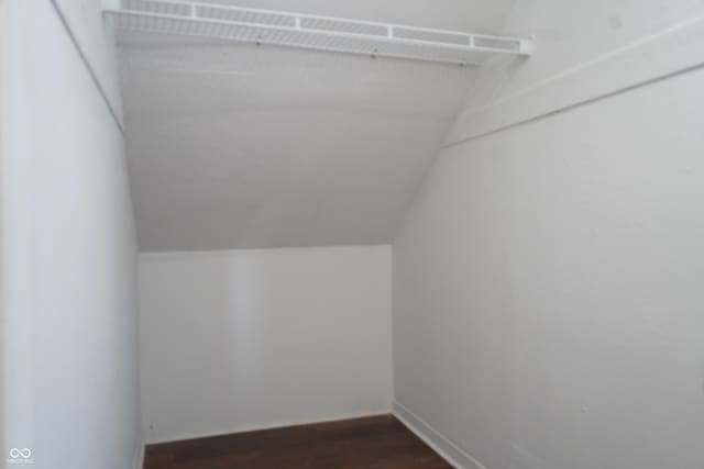 3554 N Illinois St, Indianapolis, IN 46208 - spacious closet with dark wood-style flooring and lofted ceiling