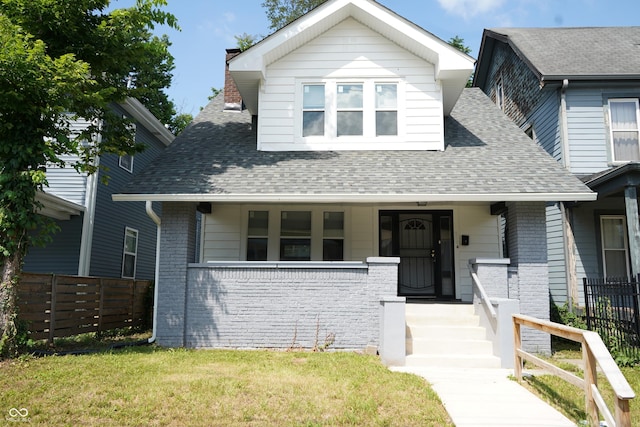 3554 N Illinois St, Indianapolis, IN 46208 - bungalow with covered porch, roof with shingles, brick siding, and a chimney