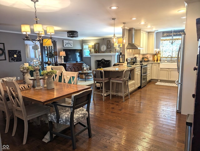 3236 Spruce St, Columbus, IN 47203 - dining space with a chandelier, crown molding, dark wood-style floors, and recessed lighting