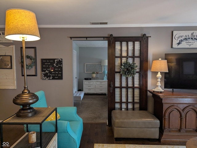 3236 Spruce St, Columbus, IN 47203 - living room featuring wood finished floors, crown molding, and a barn door
