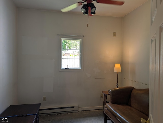 3236 Spruce St, Columbus, IN 47203 - sitting room with a baseboard heating unit, ceiling fan, and concrete flooring