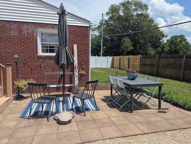 3236 Spruce St, Columbus, IN 47203 - fenced backyard with outdoor dining area and a patio area