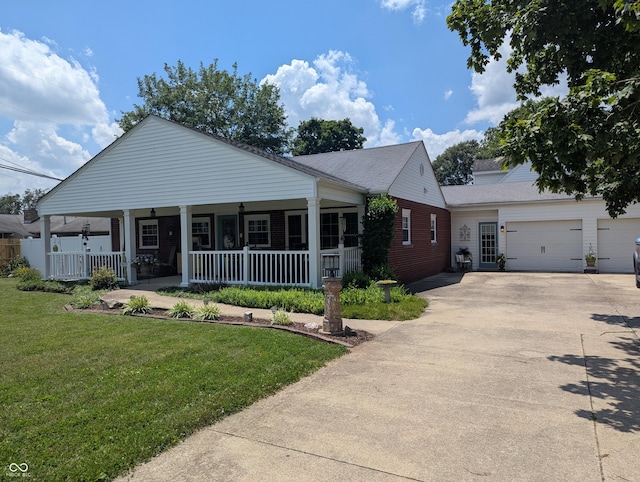3236 Spruce St, Columbus, IN 47203 - view of front of house with covered porch, driveway, a front lawn, and roof with shingles