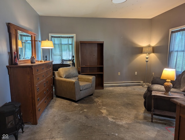 3236 Spruce St, Columbus, IN 47203 - living room featuring a baseboard heating unit, concrete flooring, and plenty of natural light
