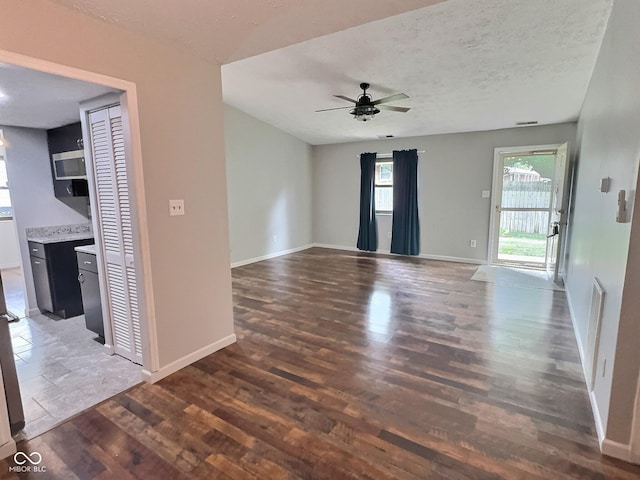 2975 Two Worlds Dr, Columbus, IN 47201 - unfurnished room with wood finished floors, a ceiling fan, and a textured ceiling