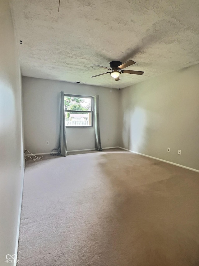 2975 Two Worlds Dr, Columbus, IN 47201 - empty room with a ceiling fan, a textured ceiling, and carpet floors