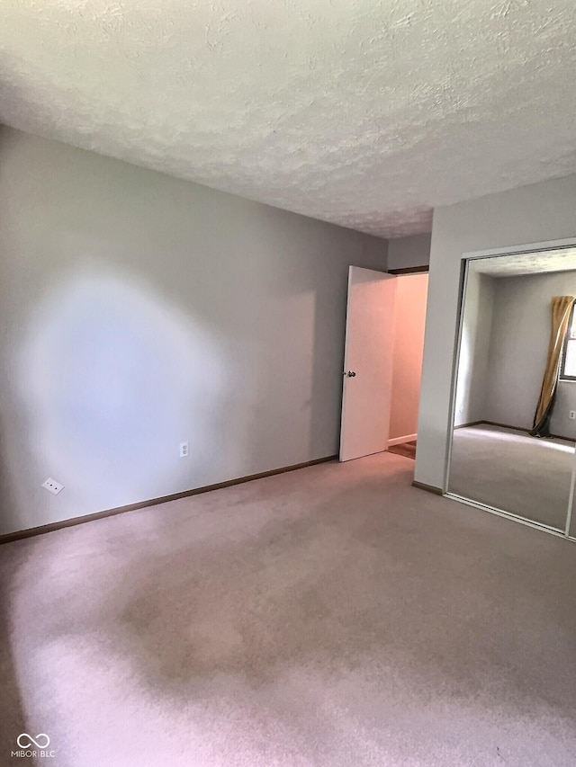 2975 Two Worlds Dr, Columbus, IN 47201 - unfurnished bedroom with carpet, a closet, and a textured ceiling