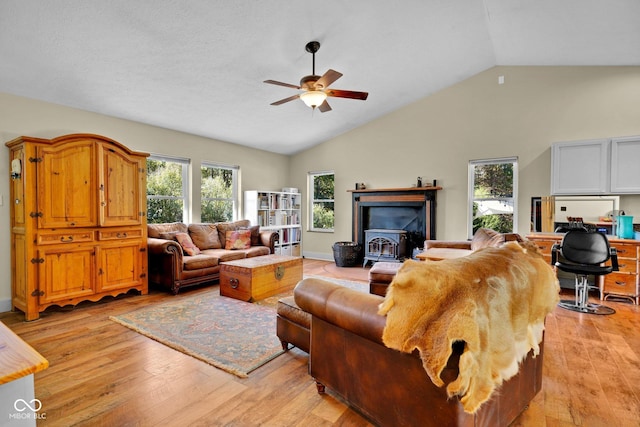 9970 N Brown Ln, Gosport, IN 47433 - living room with a ceiling fan, light wood-style floors, healthy amount of natural light, high vaulted ceiling, and a wood stove