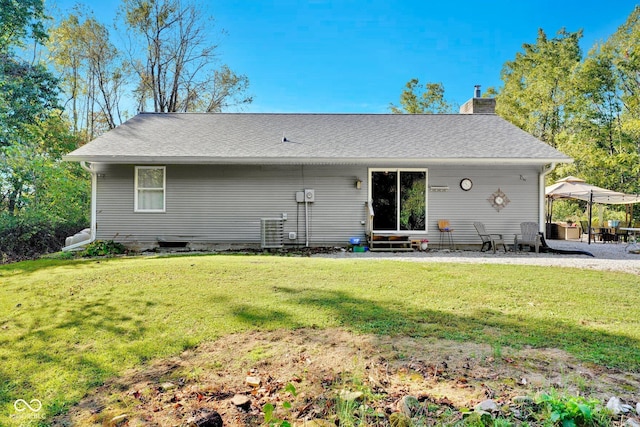9970 N Brown Ln, Gosport, IN 47433 - back of property with entry steps, a chimney, a yard, and a patio area