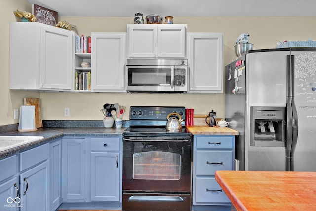 9970 N Brown Ln, Gosport, IN 47433 - kitchen featuring appliances with stainless steel finishes, butcher block counters, open shelves, and white cabinets