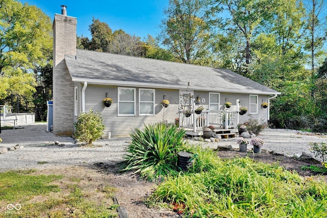 9970 N Brown Ln, Gosport, IN 47433 - view of front of property featuring a wooden deck, a chimney, and a shingled roof