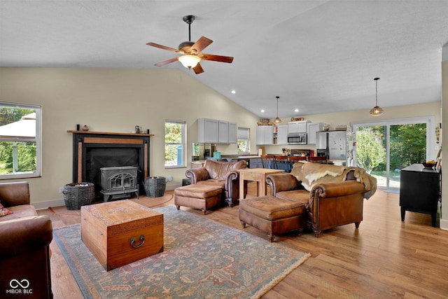 9970 N Brown Ln, Gosport, IN 47433 - living room featuring a wood stove, ceiling fan, light wood-style flooring, plenty of natural light, and lofted ceiling
