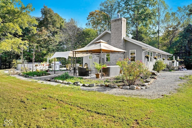 9970 N Brown Ln, Gosport, IN 47433 - rear view of property featuring a patio area, a yard, and a chimney