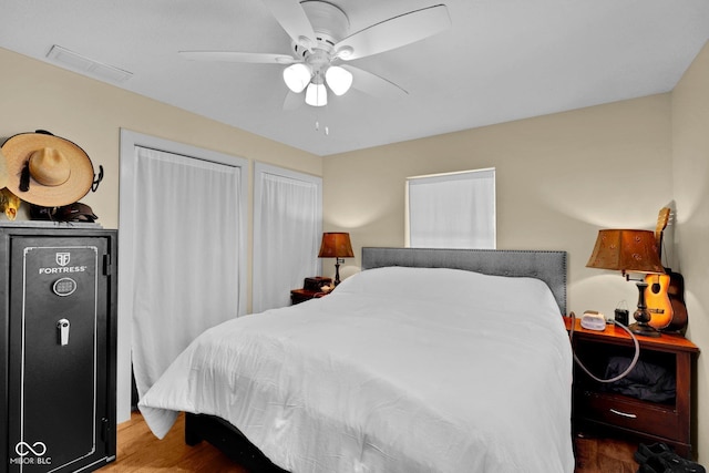 9970 N Brown Ln, Gosport, IN 47433 - bedroom with wood finished floors, a ceiling fan, and two closets