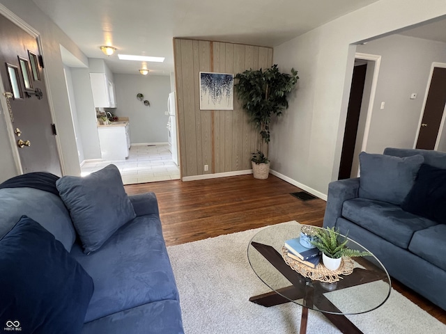 1726 N Linwood Ave, Indianapolis, IN 46218 - living room featuring wood finished floors and wooden walls