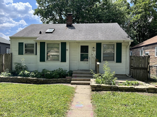 1726 N Linwood Ave, Indianapolis, IN 46218 - view of front of house featuring a chimney and roof with shingles